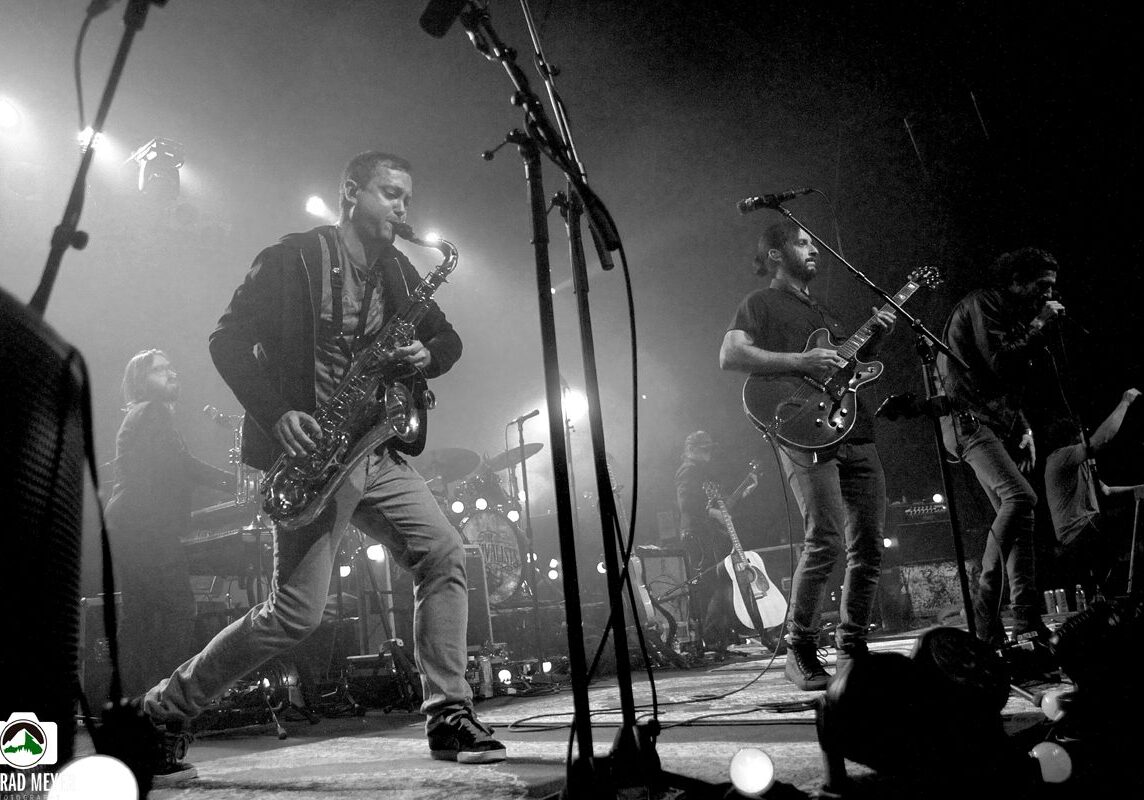 Band performing live on stage, black-and-white.
