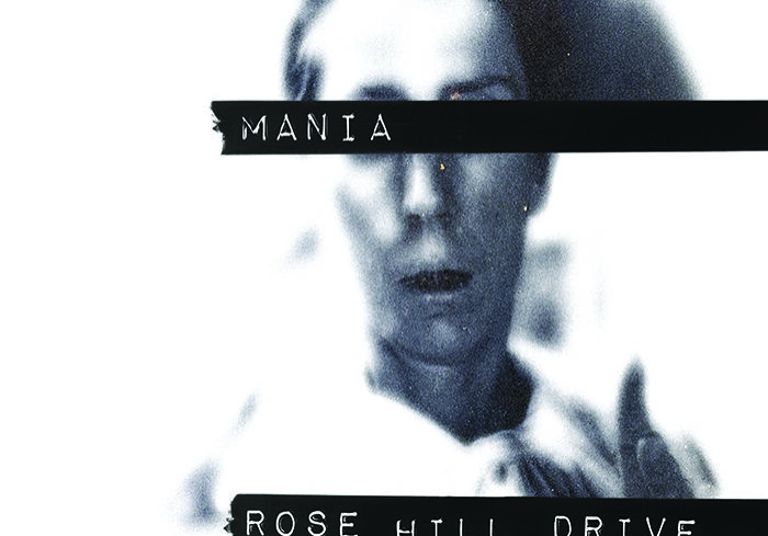 Blurred face with text "Mania" and "Rose Hill Drive".