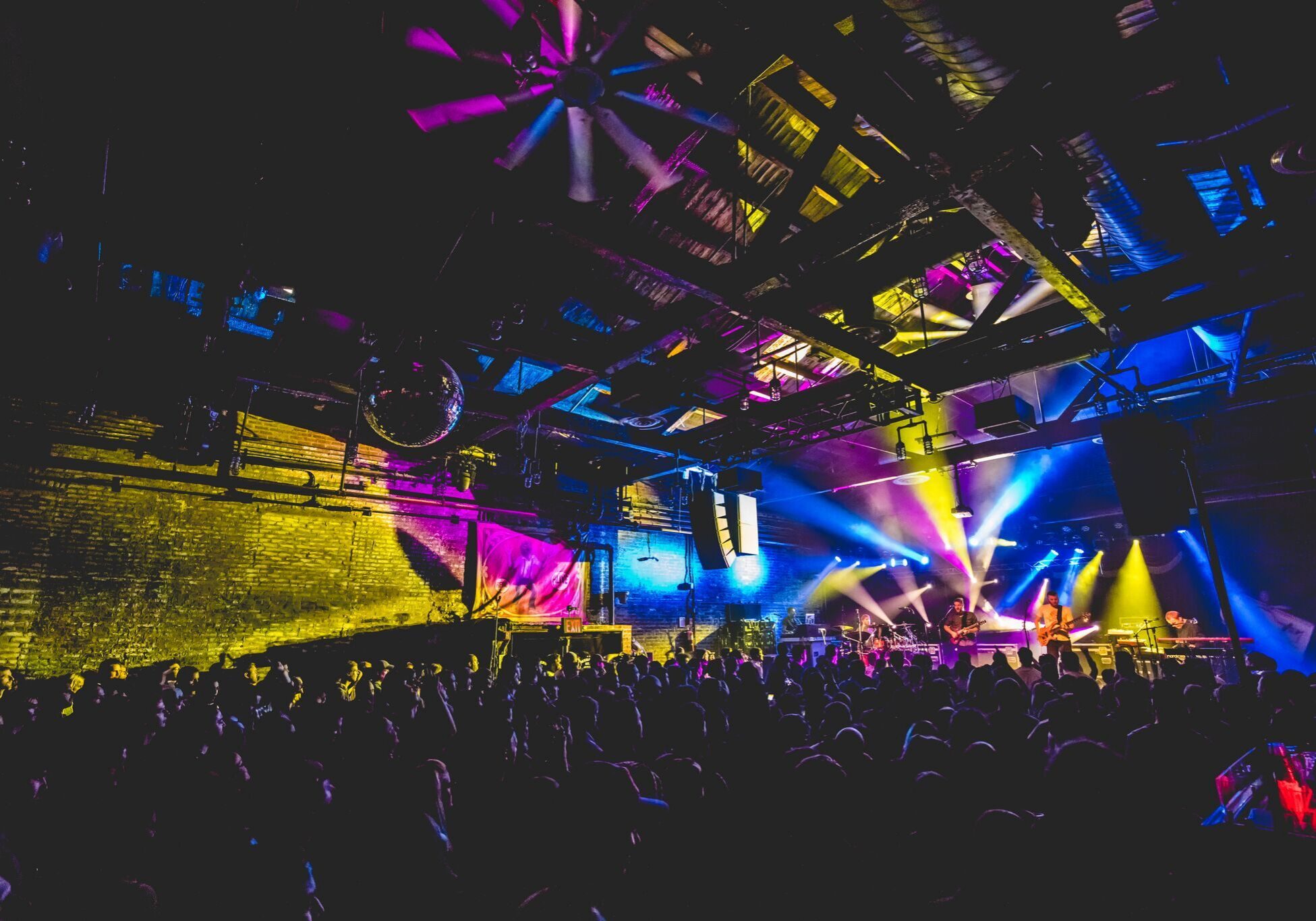 Concert with colorful stage lights and crowd.
