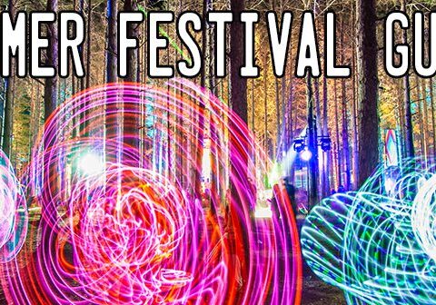 Colorful light trails in a forest festival.