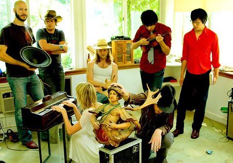 Group of people with musical instruments indoors.