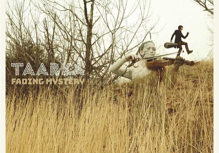 Violinist in field with running figure.