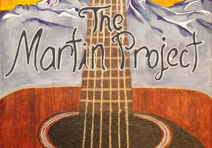 Guitar with mountains and musical notes background.