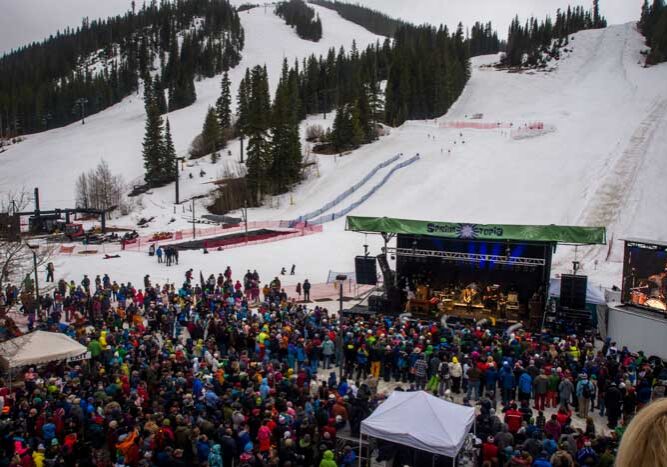 Outdoor concert at snowy mountain ski resort.